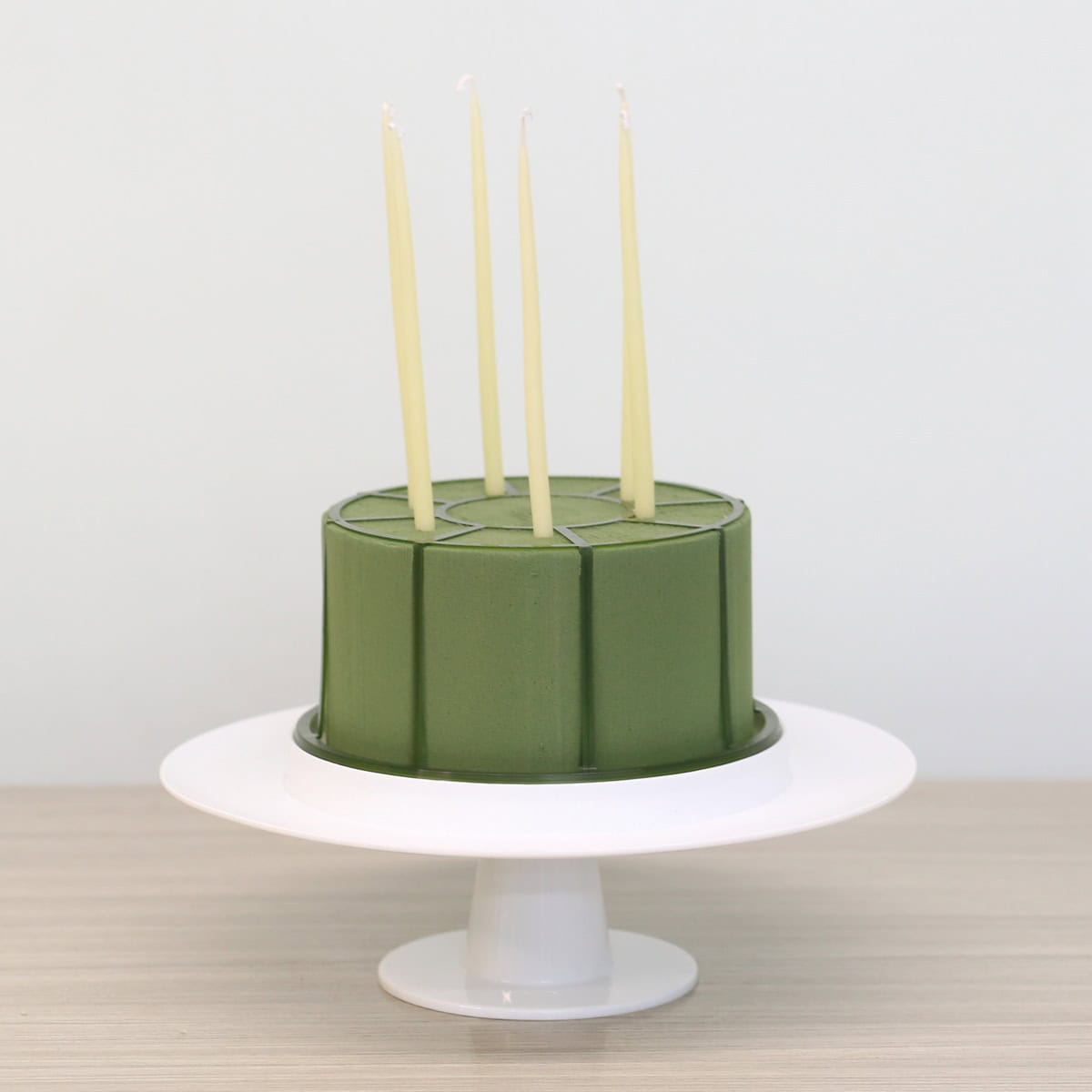 floral cake stand with oasis foam and tapered candles for DIY centerpiece