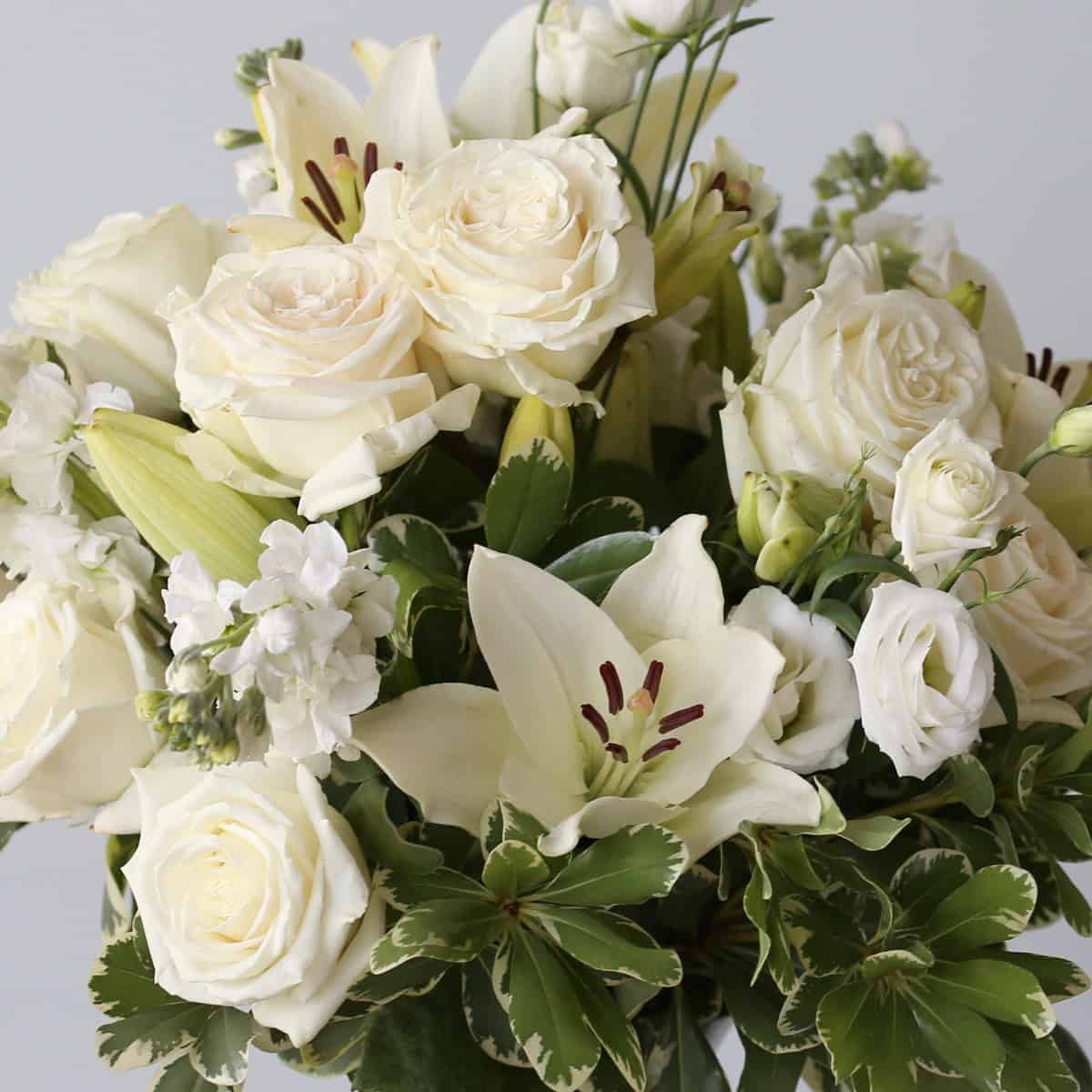 white roses lilies lisianthus close up bulk flower bundle wedding flowers